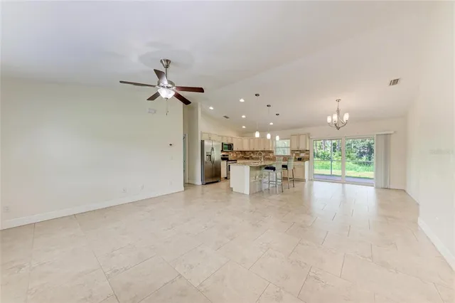a view of kitchen with a sink and a refrigerator