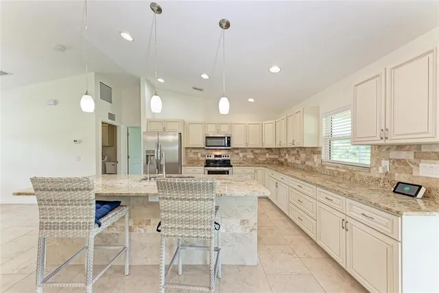 a kitchen with a refrigerator and a sink