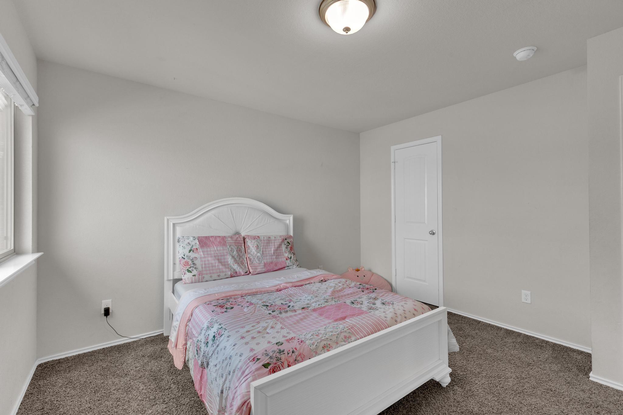 104 Uncle Billy Way Jarrell, TX 76537 - Photo 32 of 38 A well-lit room with plush carpeting, offering a comfortable and peaceful retreat.