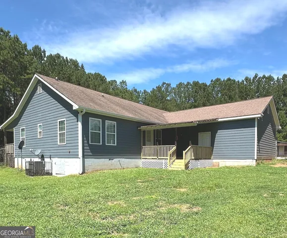 a view of a room with wooden floor fan and a floor to ceiling window
