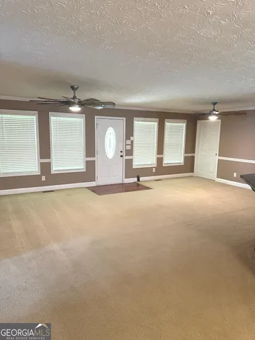 an empty room with a empty space and windows