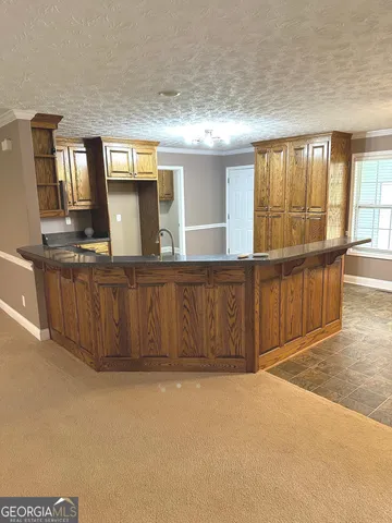 wooden floor with a kitchen