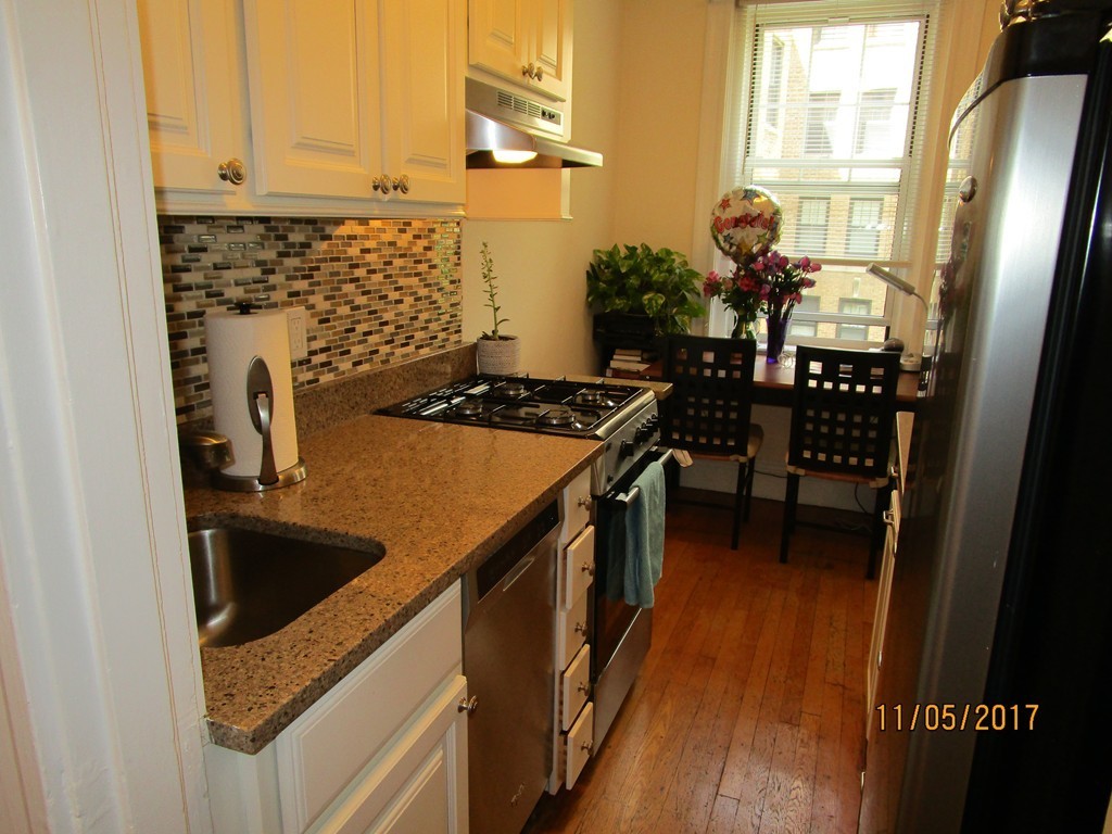 a kitchen with sink refrigerator and window
