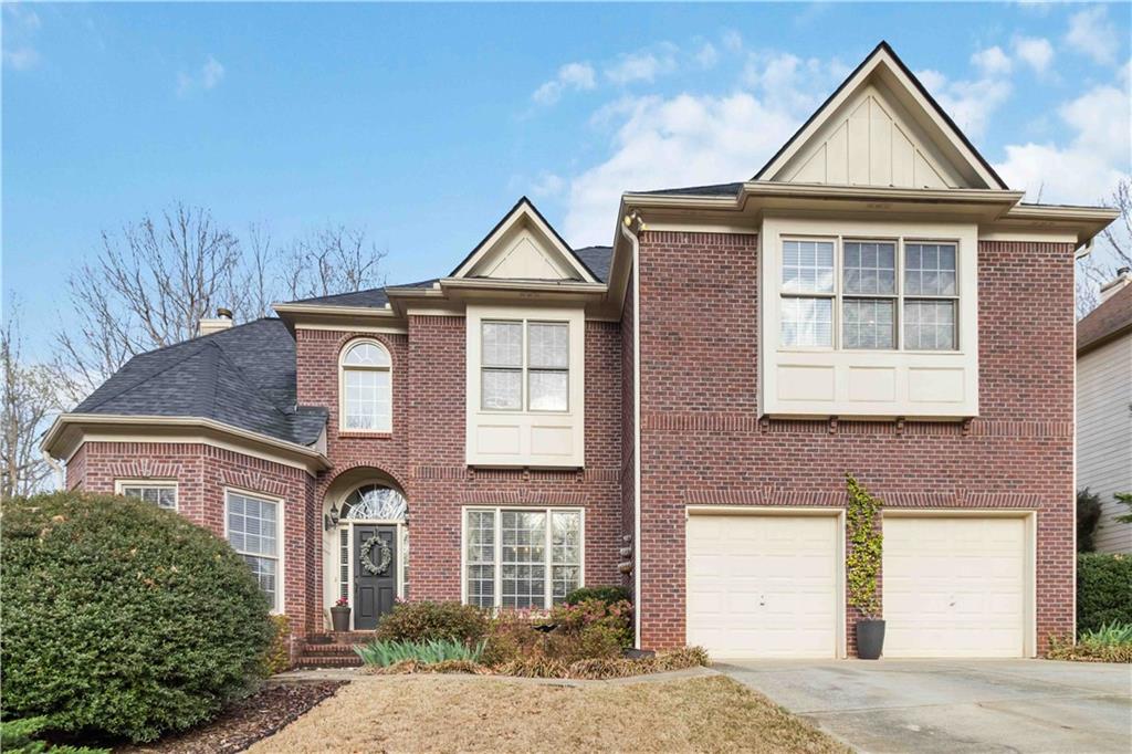 3770 Summit Gate Drive Suwanee, GA 30024 - Photo 1 of 1 a front view of a house with a yard and garage