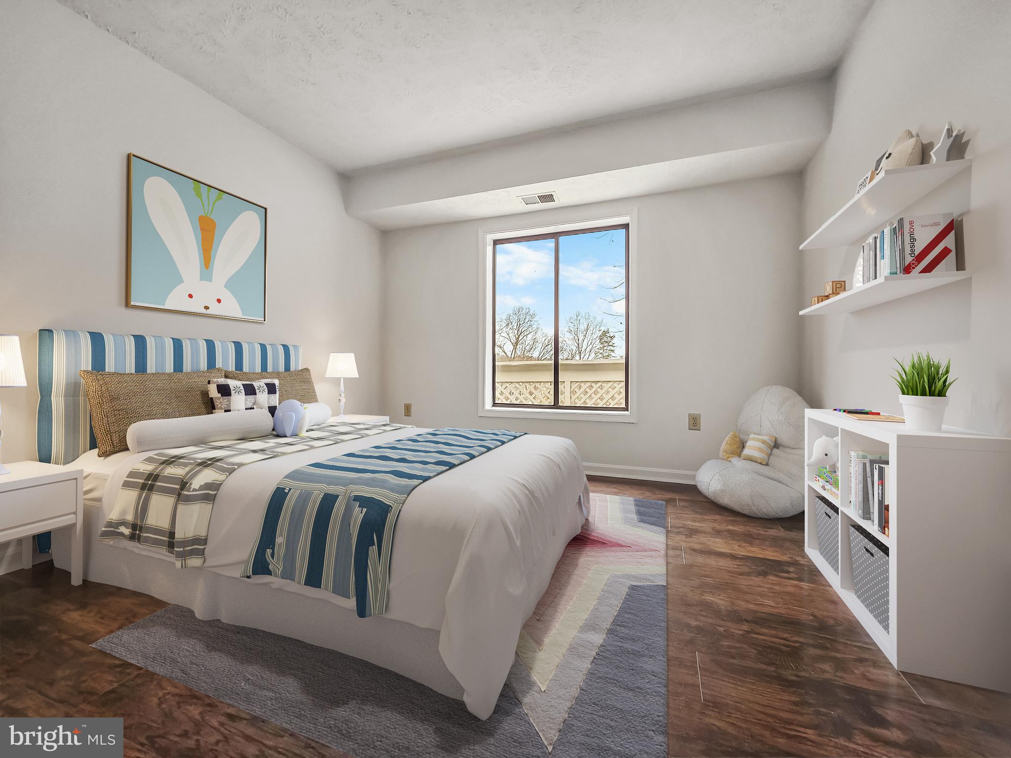 58 Windbrooke Circle, Unit 58 Gaithersburg, MD 20879 - Photo 11 of 28 a bedroom with a bed and wooden floor