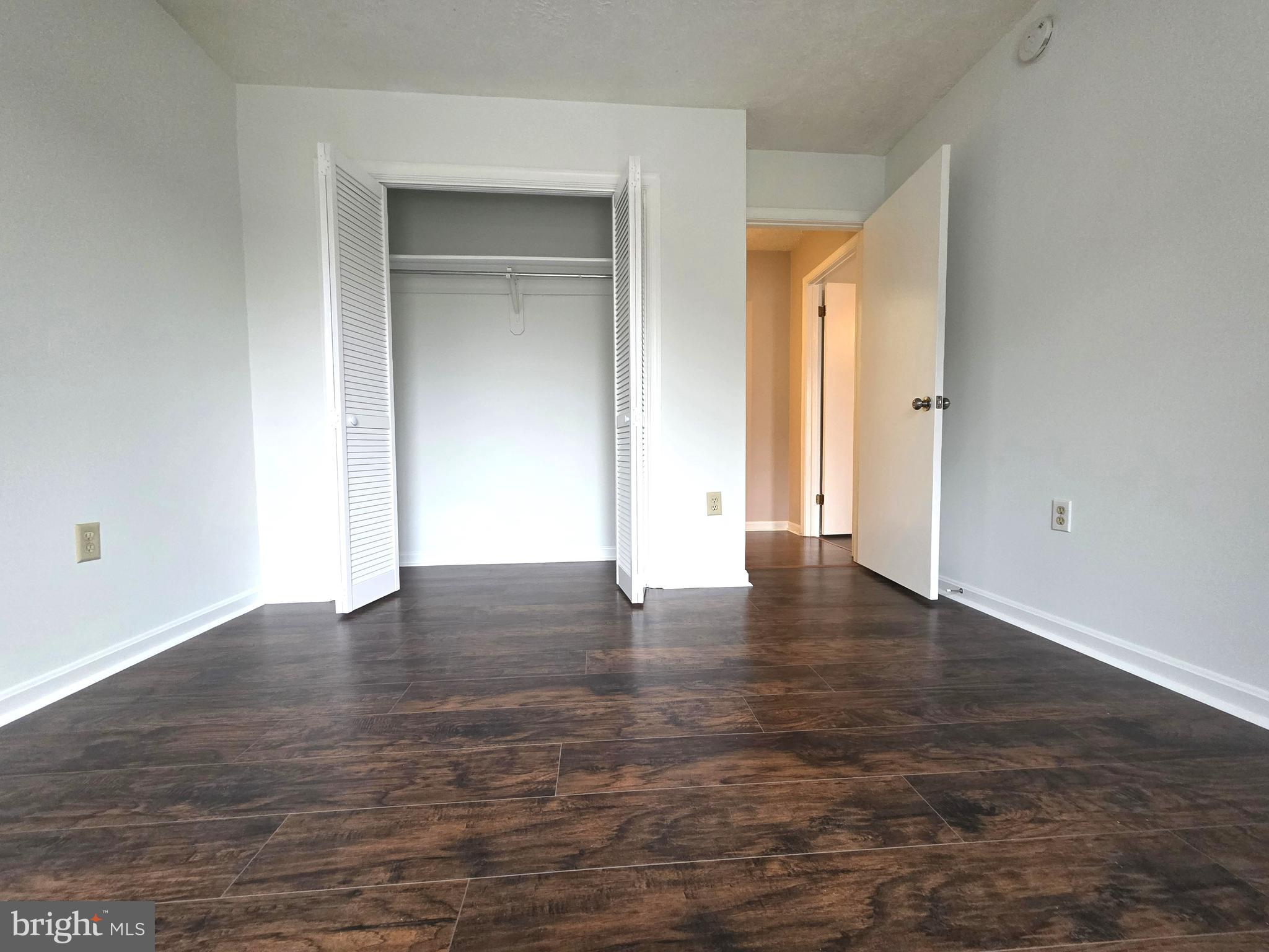 58 Windbrooke Circle, Unit 58 Gaithersburg, MD 20879 - Photo 12 of 28 an empty room with wooden floor and closet