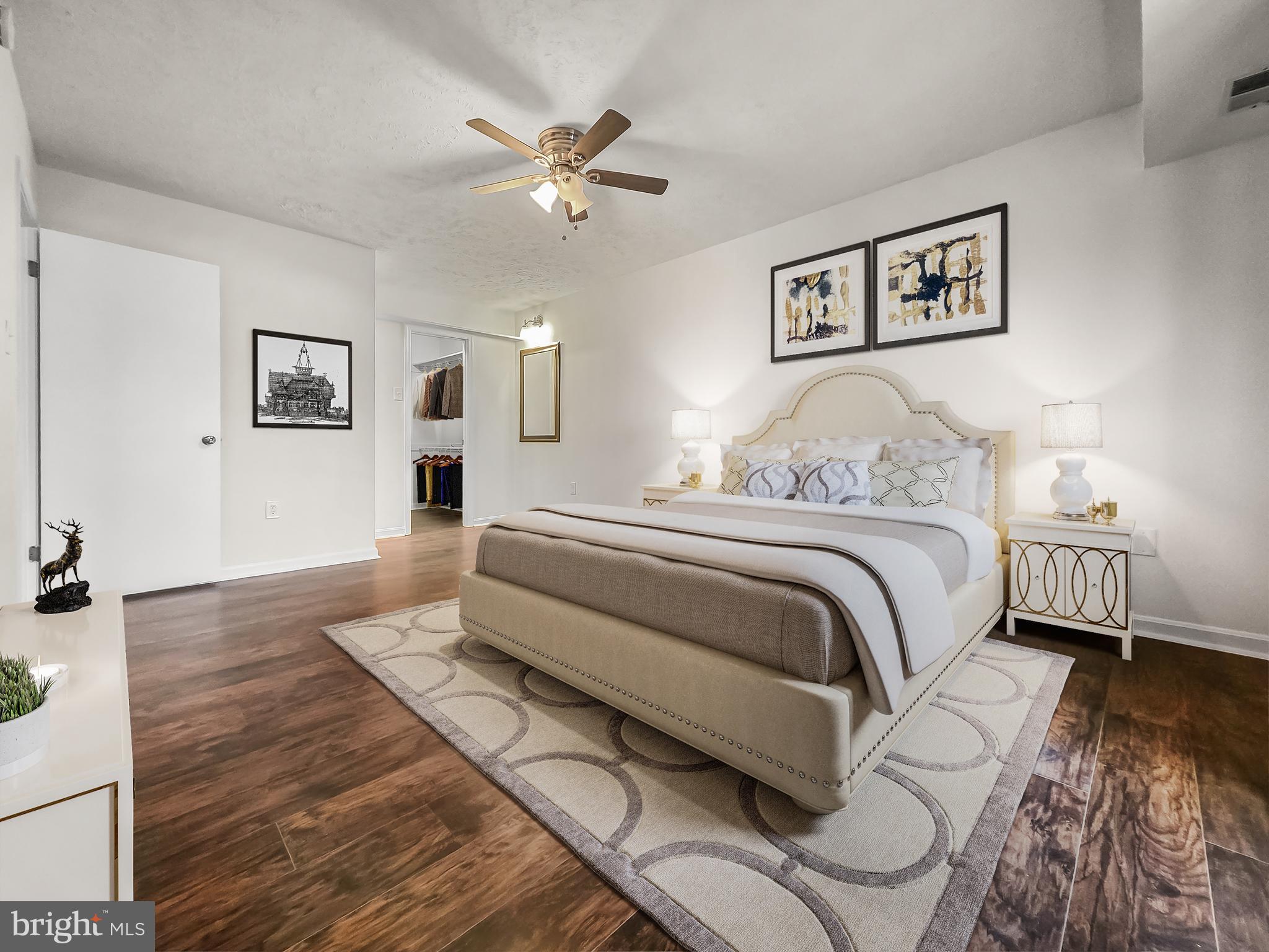 58 Windbrooke Circle, Unit 58 Gaithersburg, MD 20879 - Photo 14 of 28 a bedroom with a large bed and a chandelier