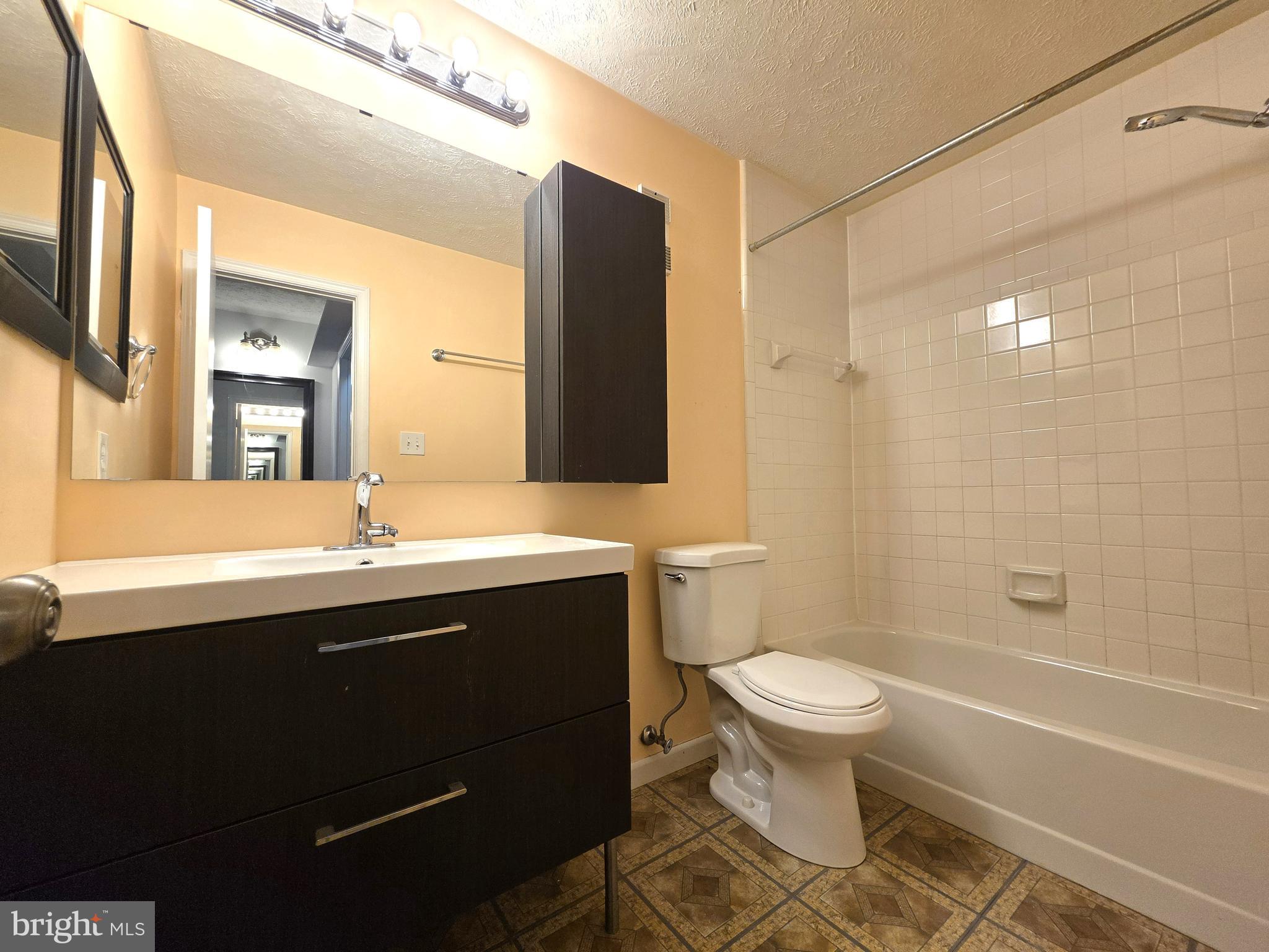 58 Windbrooke Circle, Unit 58 Gaithersburg, MD 20879 - Photo 16 of 28 a bathroom with a sink a toilet and shower