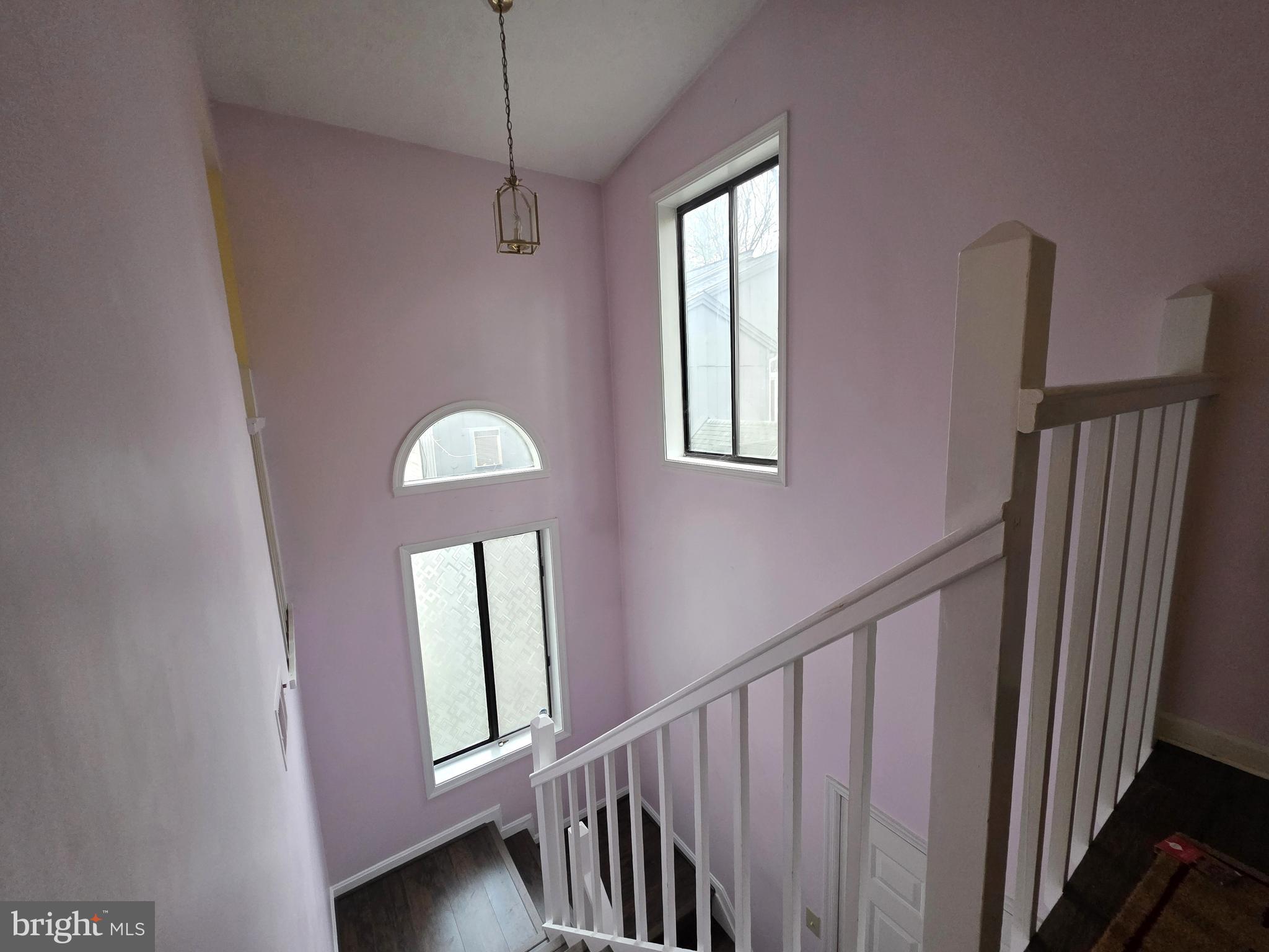 58 Windbrooke Circle, Unit 58 Gaithersburg, MD 20879 - Photo 19 of 28 a view of a hallway with windows and stairs