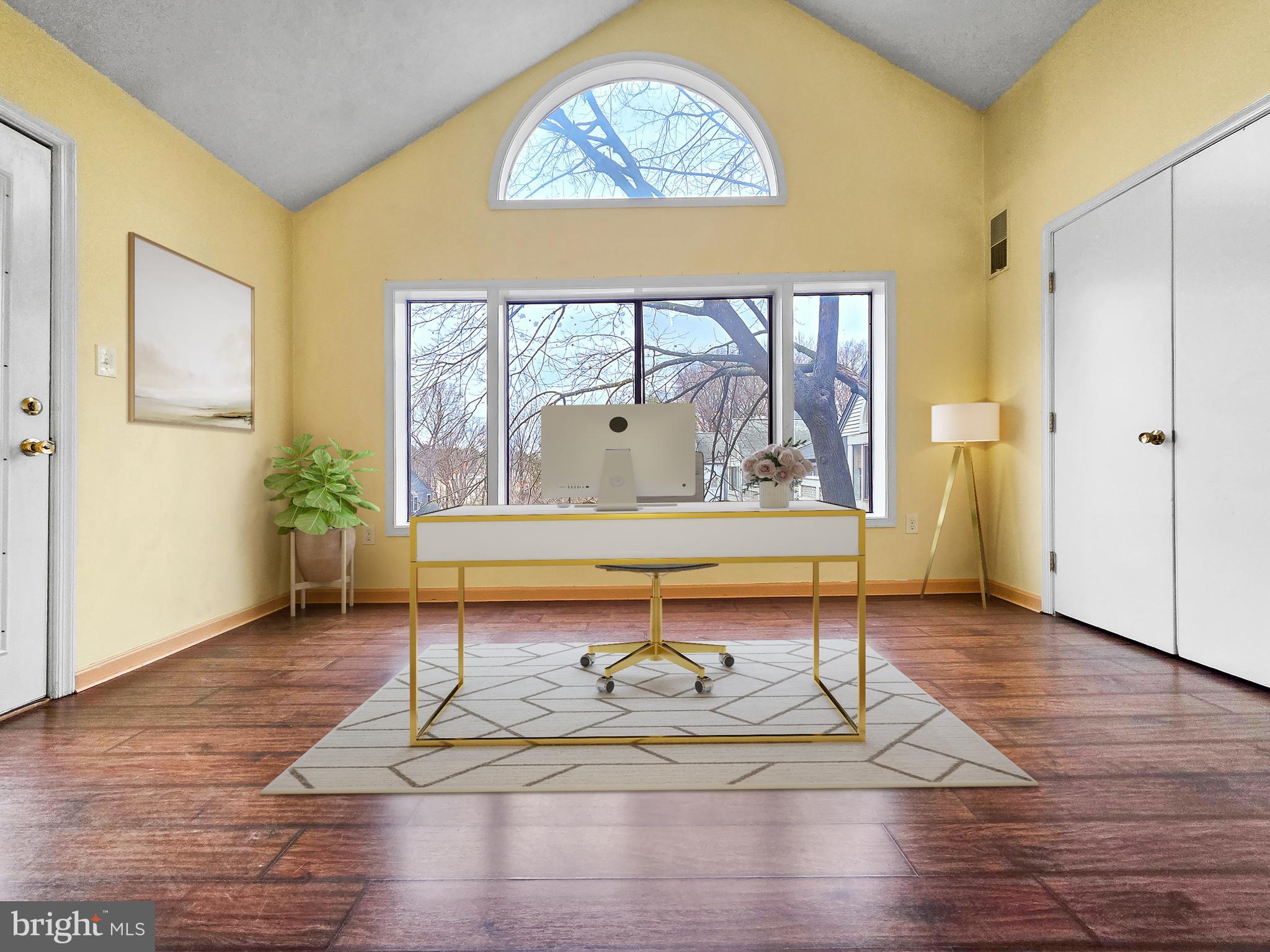 58 Windbrooke Circle, Unit 58 Gaithersburg, MD 20879 - Photo 2 of 28 a living room with wooden floor and a table