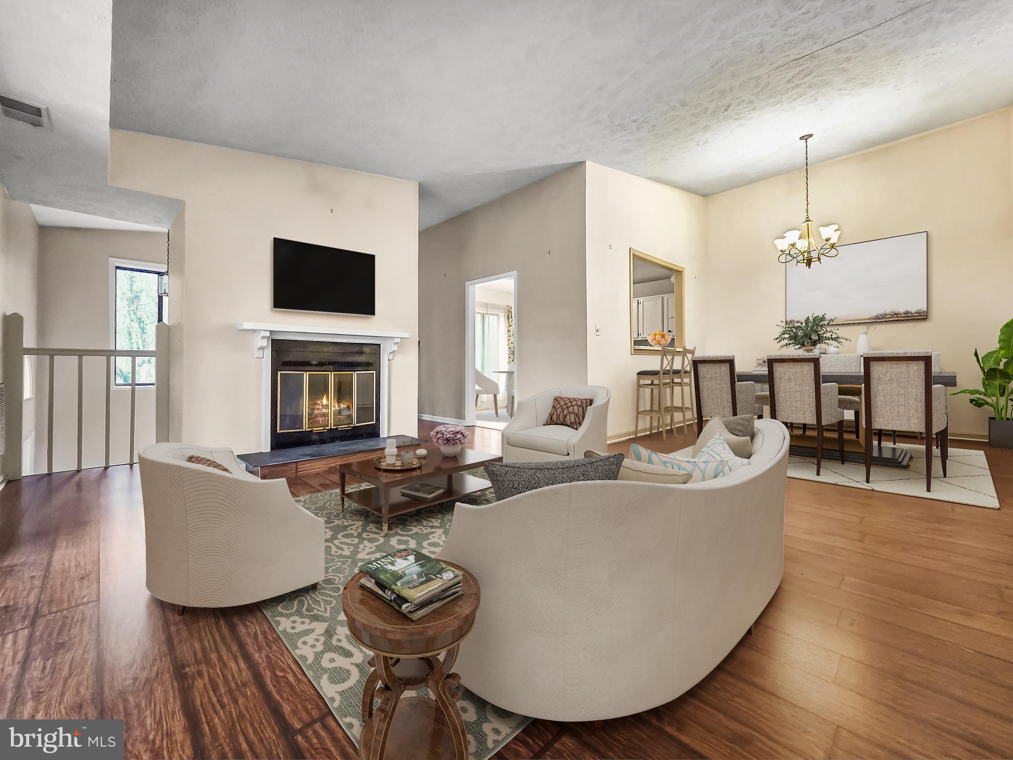 58 Windbrooke Circle, Unit 58 Gaithersburg, MD 20879 - Photo 5 of 28 a living room with fireplace furniture and a flat screen tv