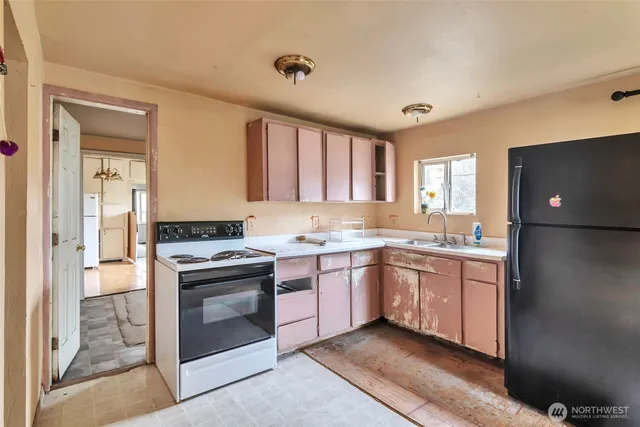 a kitchen with granite countertop a sink stainless steel appliances and cabinets