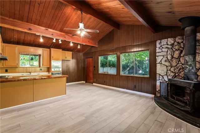 a view of an empty room with a fireplace and a window