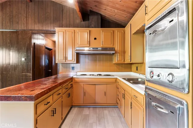 a kitchen with a sink stove and cabinets