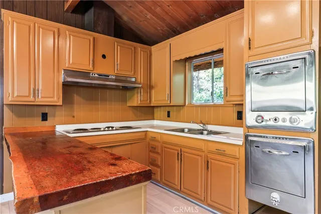 a kitchen with stainless steel appliances granite countertop a sink and cabinets