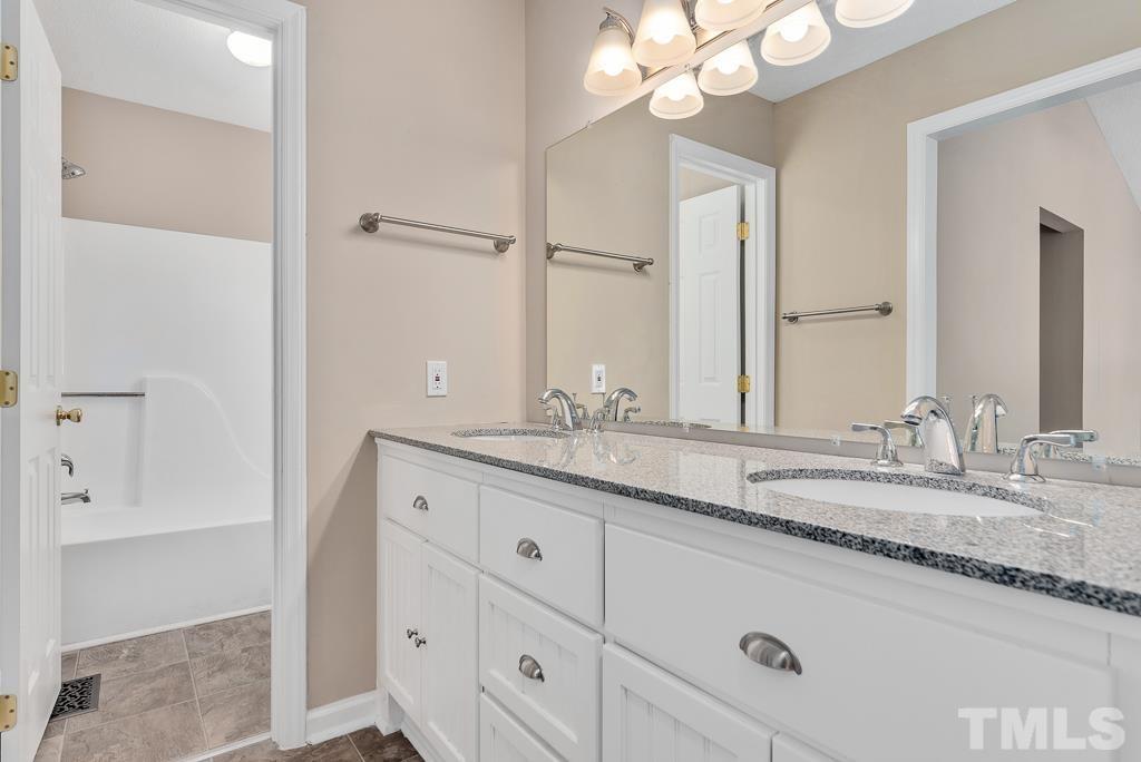 3308 Castlegate Drive Raleigh, NC 27616 - Photo 13 of 22 a bathroom with a granite countertop double vanity sink and mirror