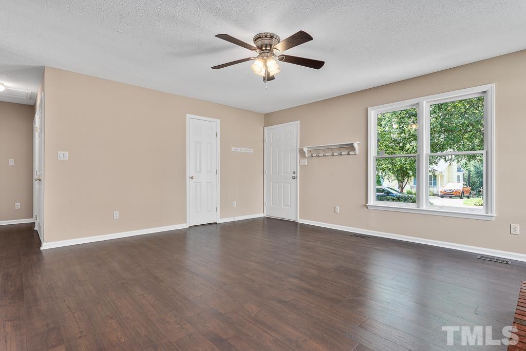3308 Castlegate Drive Raleigh, NC 27616 - Photo 4 of 22 an empty room with wooden floor and windows