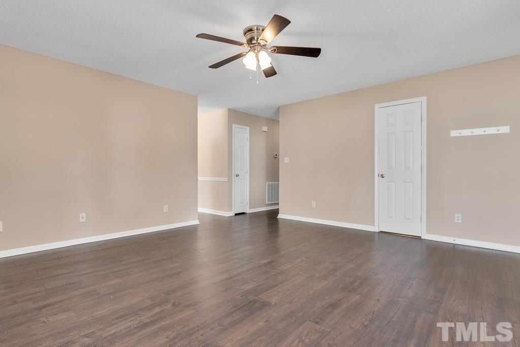 3308 Castlegate Drive Raleigh, NC 27616 - Photo 5 of 22 a view of an empty room with wooden floor