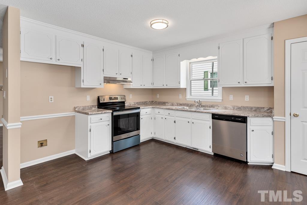 3308 Castlegate Drive Raleigh, NC 27616 - Photo 6 of 22 a kitchen with granite countertop white cabinets and white appliances