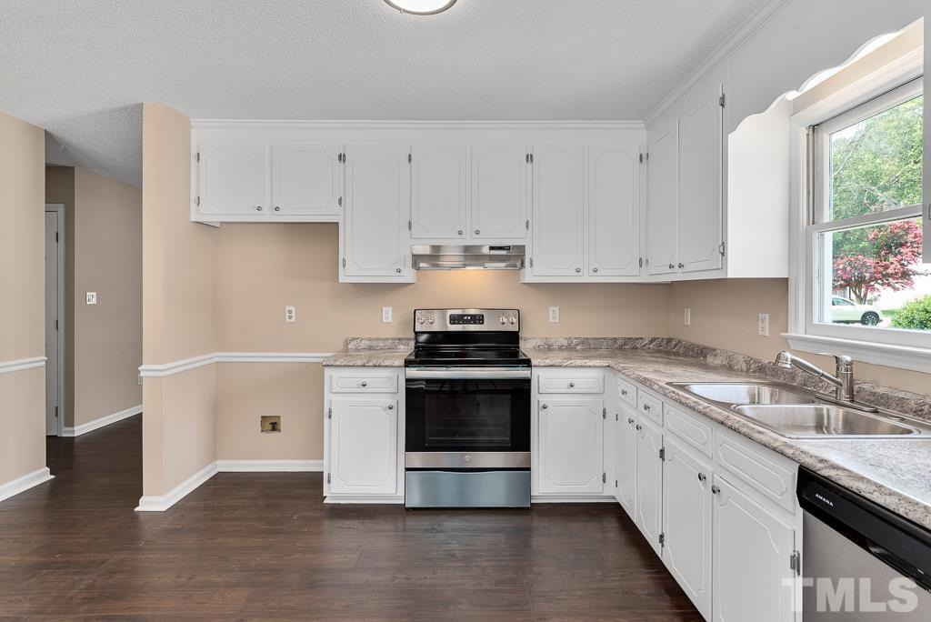 3308 Castlegate Drive Raleigh, NC 27616 - Photo 7 of 22 a kitchen with granite countertop white cabinets and white appliances