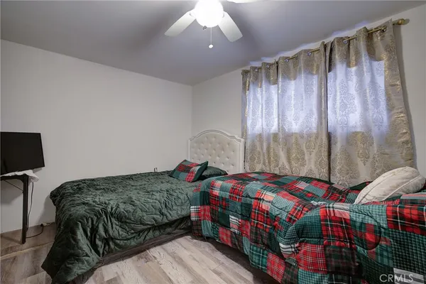 a bedroom with a bed a window and a mirror