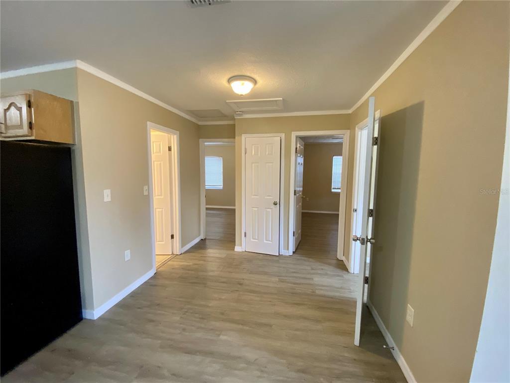 38313 Tucker Road Zephyrhills, FL 33542 - Photo 11 of 46 a view of a hallway with wooden shelves