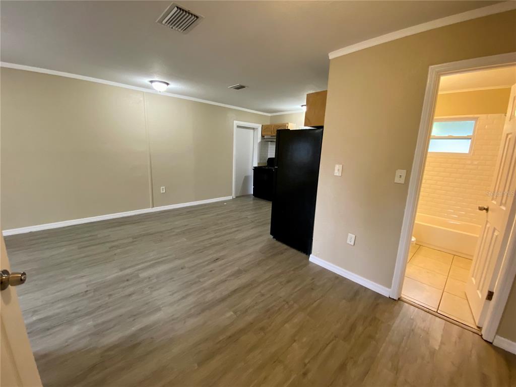 38313 Tucker Road Zephyrhills, FL 33542 - Photo 12 of 46 an empty room with wooden floor and a window