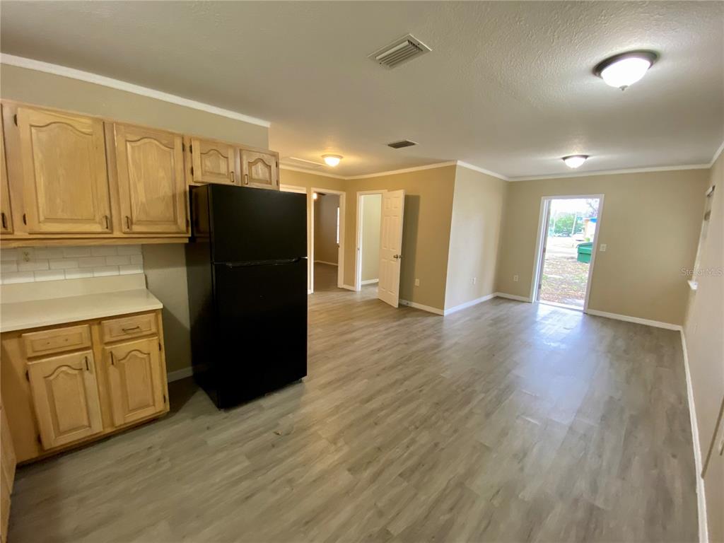 38313 Tucker Road Zephyrhills, FL 33542 - Photo 16 of 46 a kitchen with stainless steel appliances a refrigerator and wooden cabinets
