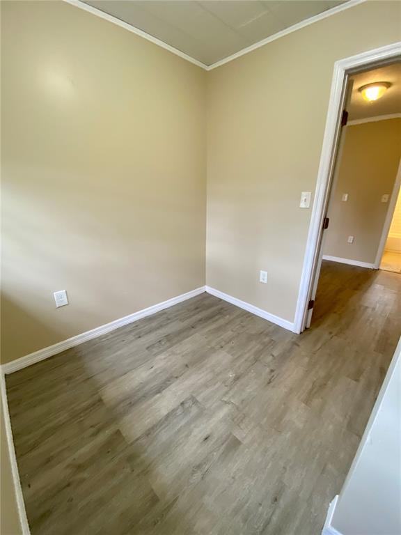 38313 Tucker Road Zephyrhills, FL 33542 - Photo 19 of 46 an empty room with wooden floor and mirror