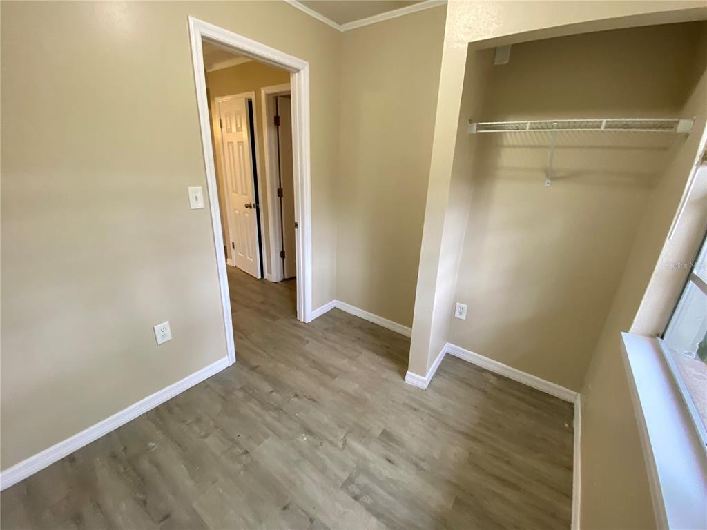 38313 Tucker Road Zephyrhills, FL 33542 - Photo 20 of 46 an empty room with wooden floor and closet