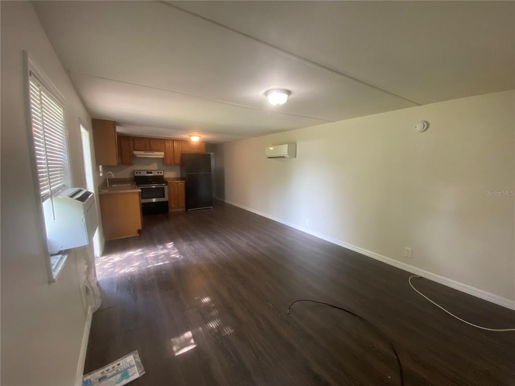 38313 Tucker Road Zephyrhills, FL 33542 - Photo 29 of 46 an empty room with wooden floor and windows