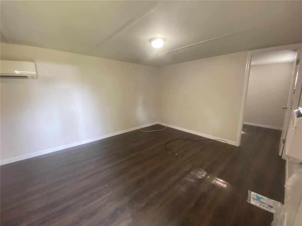 38313 Tucker Road Zephyrhills, FL 33542 - Photo 32 of 46 a view of an empty room with wooden floor