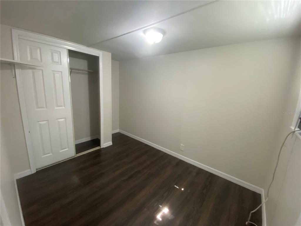 38313 Tucker Road Zephyrhills, FL 33542 - Photo 34 of 46 a view of an empty room with wooden floor