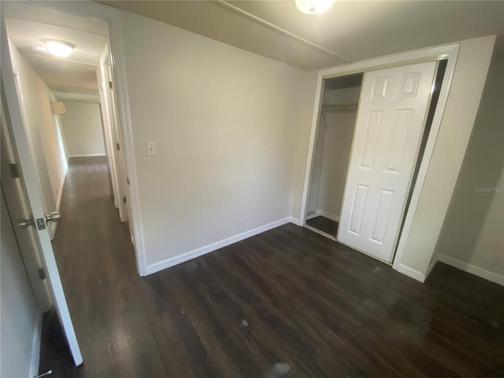 38313 Tucker Road Zephyrhills, FL 33542 - Photo 35 of 46 an empty room with wooden floor
