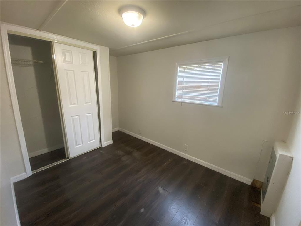 38313 Tucker Road Zephyrhills, FL 33542 - Photo 37 of 46 an empty room with wooden floor and windows