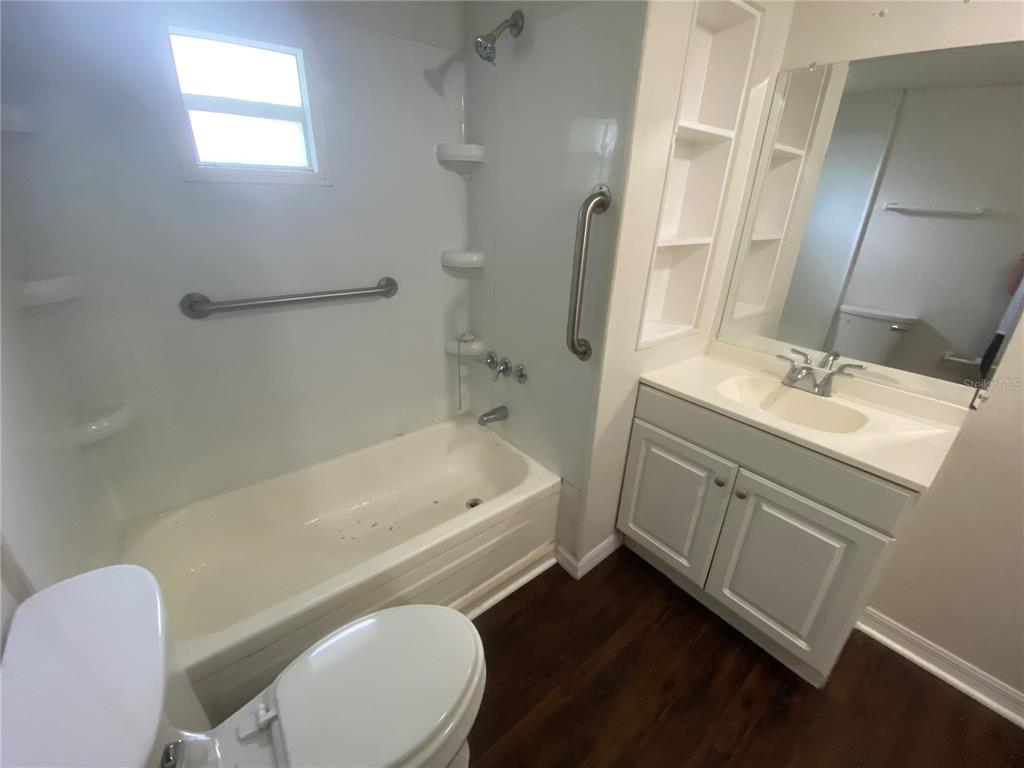 38313 Tucker Road Zephyrhills, FL 33542 - Photo 38 of 46 a bathroom with a sink a toilet a mirror and bathtub