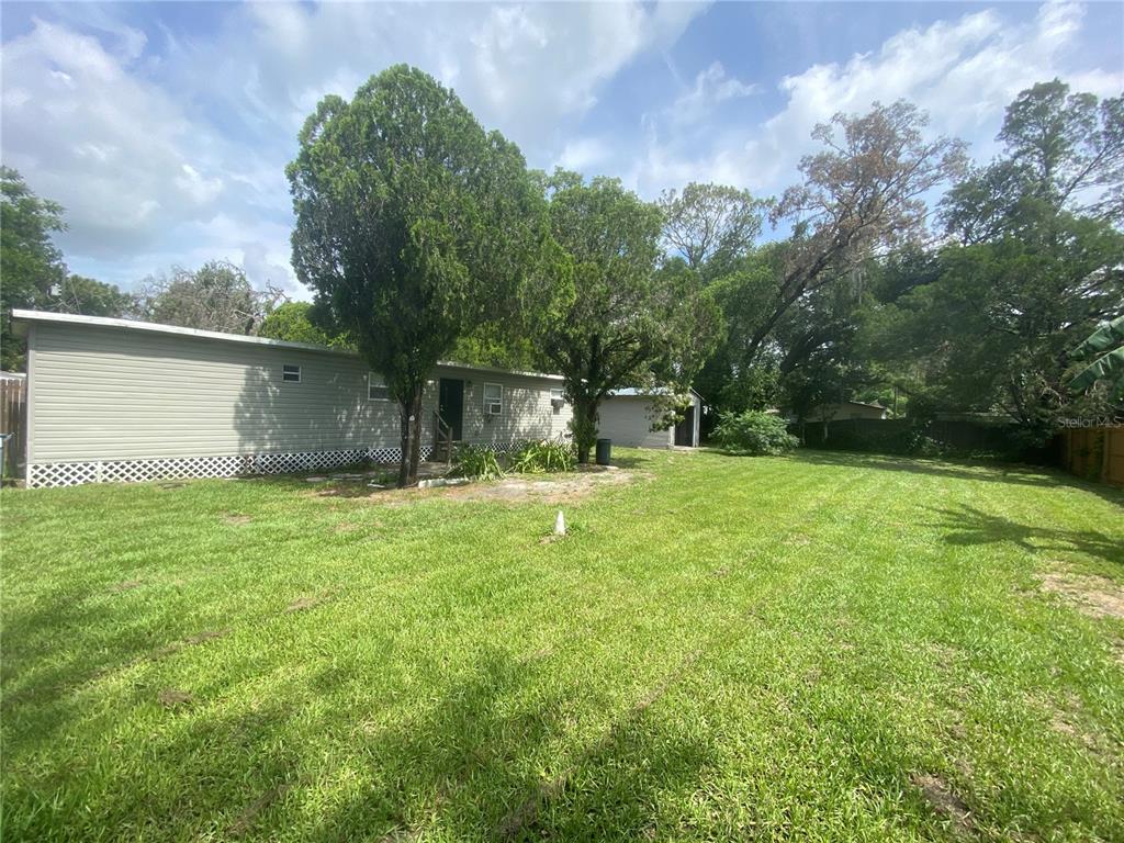 38313 Tucker Road Zephyrhills, FL 33542 - Photo 42 of 46 a backyard of a house with lots of green space
