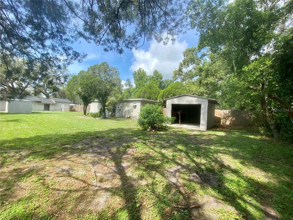 38313 Tucker Road Zephyrhills, FL 33542 - Photo 44 of 46 a backyard of a house with lots of green space