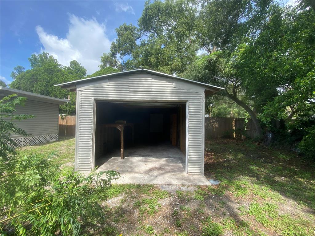 38313 Tucker Road Zephyrhills, FL 33542 - Photo 46 of 46 a view of backyard with a barn and a large tree