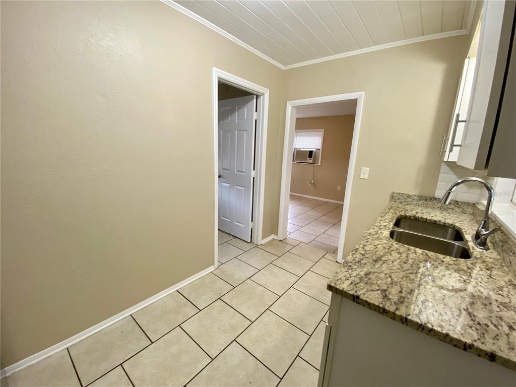 38313 Tucker Road Zephyrhills, FL 33542 - Photo 6 of 46 a bathroom with a granite countertop sink and a mirror