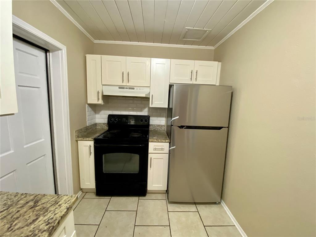 38313 Tucker Road Zephyrhills, FL 33542 - Photo 7 of 46 a kitchen with a refrigerator and a stove