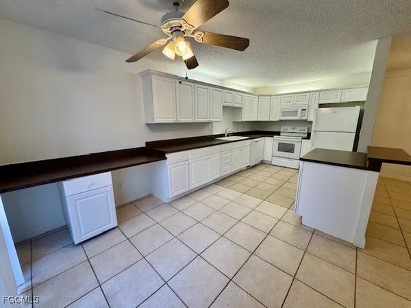 a kitchen with stainless steel appliances granite countertop a sink and cabinets