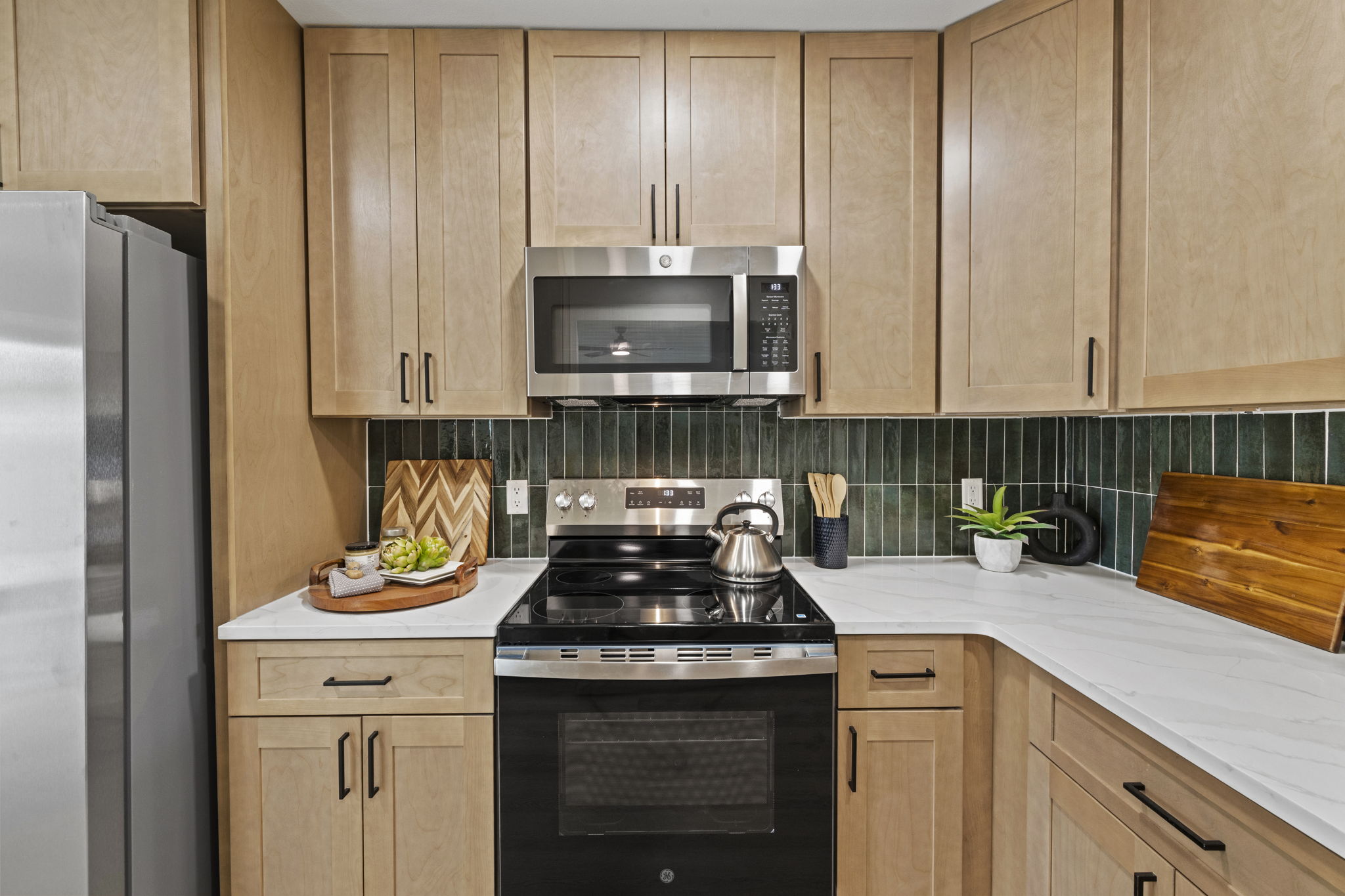 3722 Blue Cat Way Round Rock, TX 78665 - Photo 11 of 40 a kitchen with stainless steel appliances granite countertop a stove a sink and a white cabinets