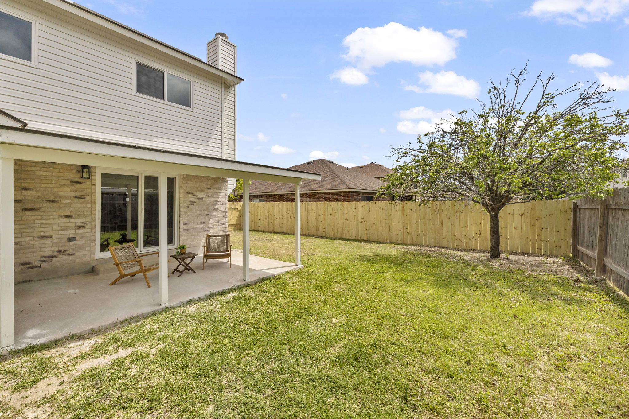 3722 Blue Cat Way Round Rock, TX 78665 - Photo 39 of 40 a view of a backyard with table and chairs and a large tree