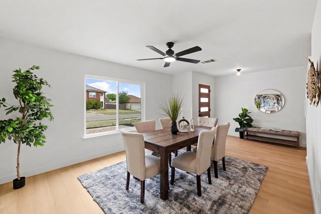 3722 Blue Cat Way Round Rock, TX 78665 - Photo 6 of 40 a view of a dining room with furniture and a potted plant