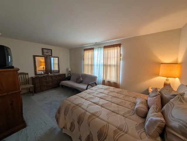 a bedroom with a bed a desk and chair