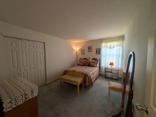 a bedroom with a bed and a dresser in it