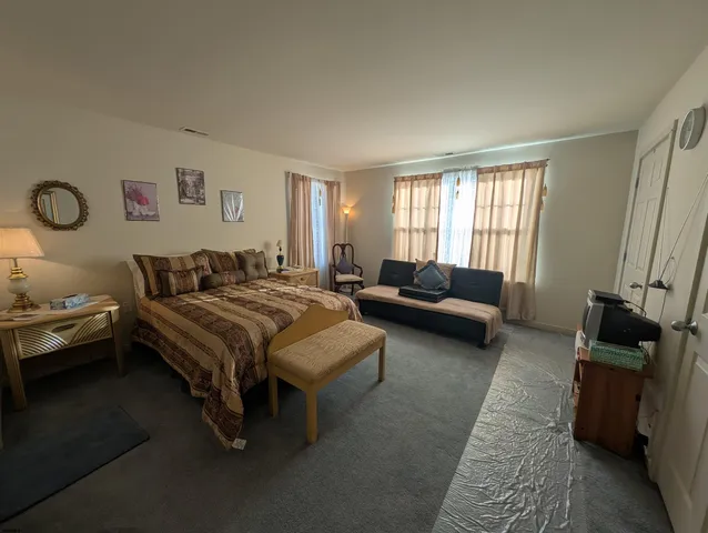 a bedroom with bed and window