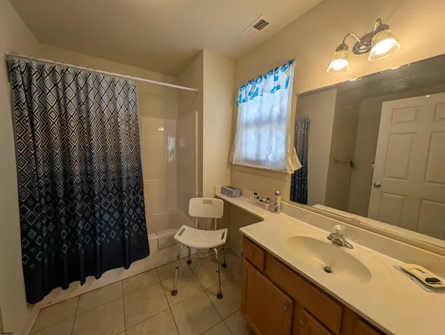 a bathroom with a shower and a sink