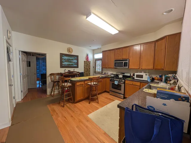a kitchen with stainless steel appliances kitchen island granite countertop a sink counter space and a window